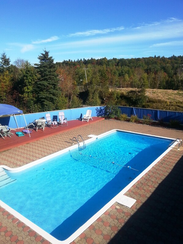 Seasonal outdoor pool, open 7:00 AM to 11:00 PM, pool umbrellas