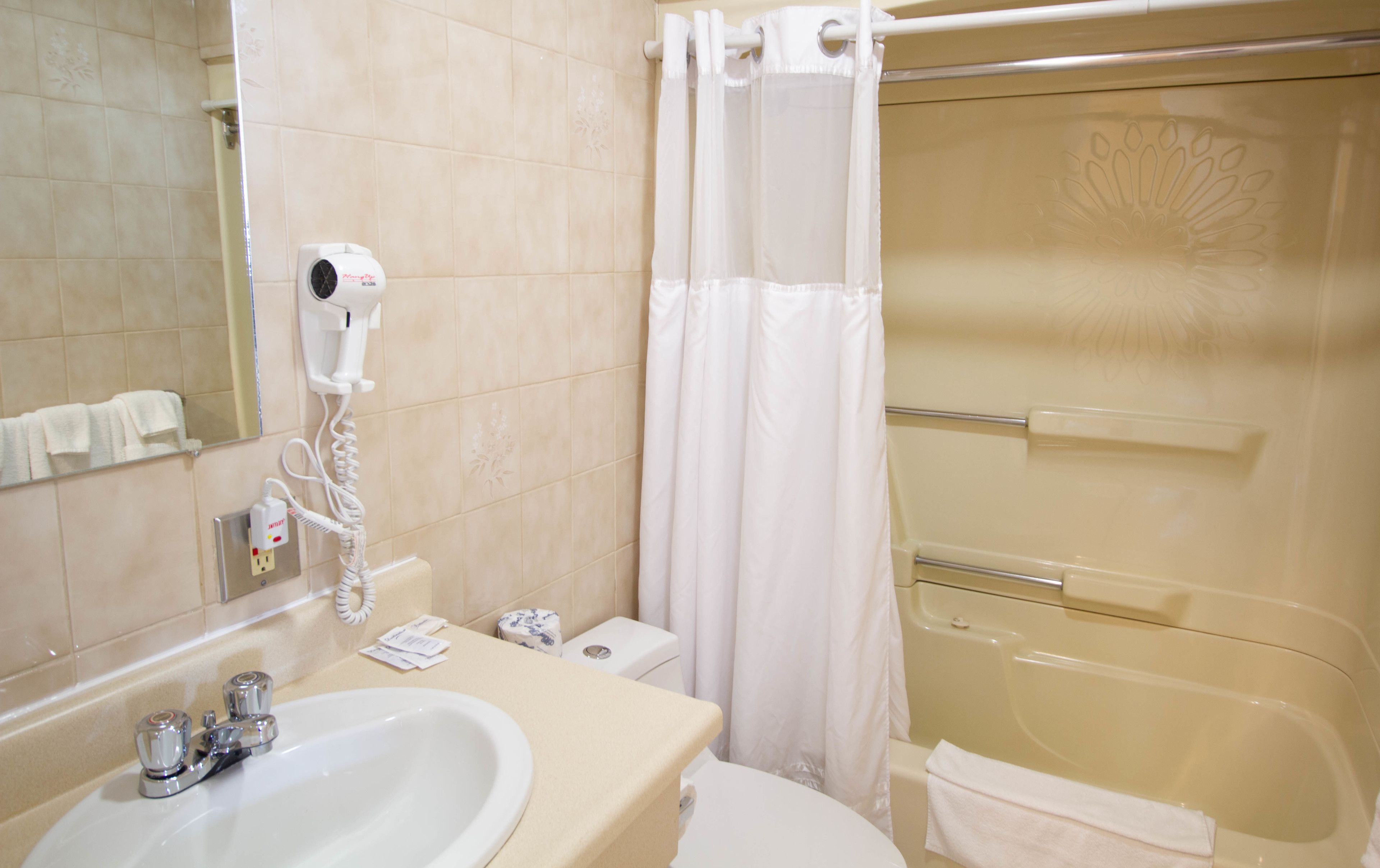 A bathroom with a sink, toilet, and shower.