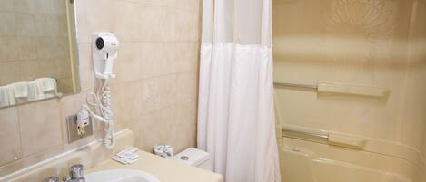 A bathroom with a sink, toilet, and shower.