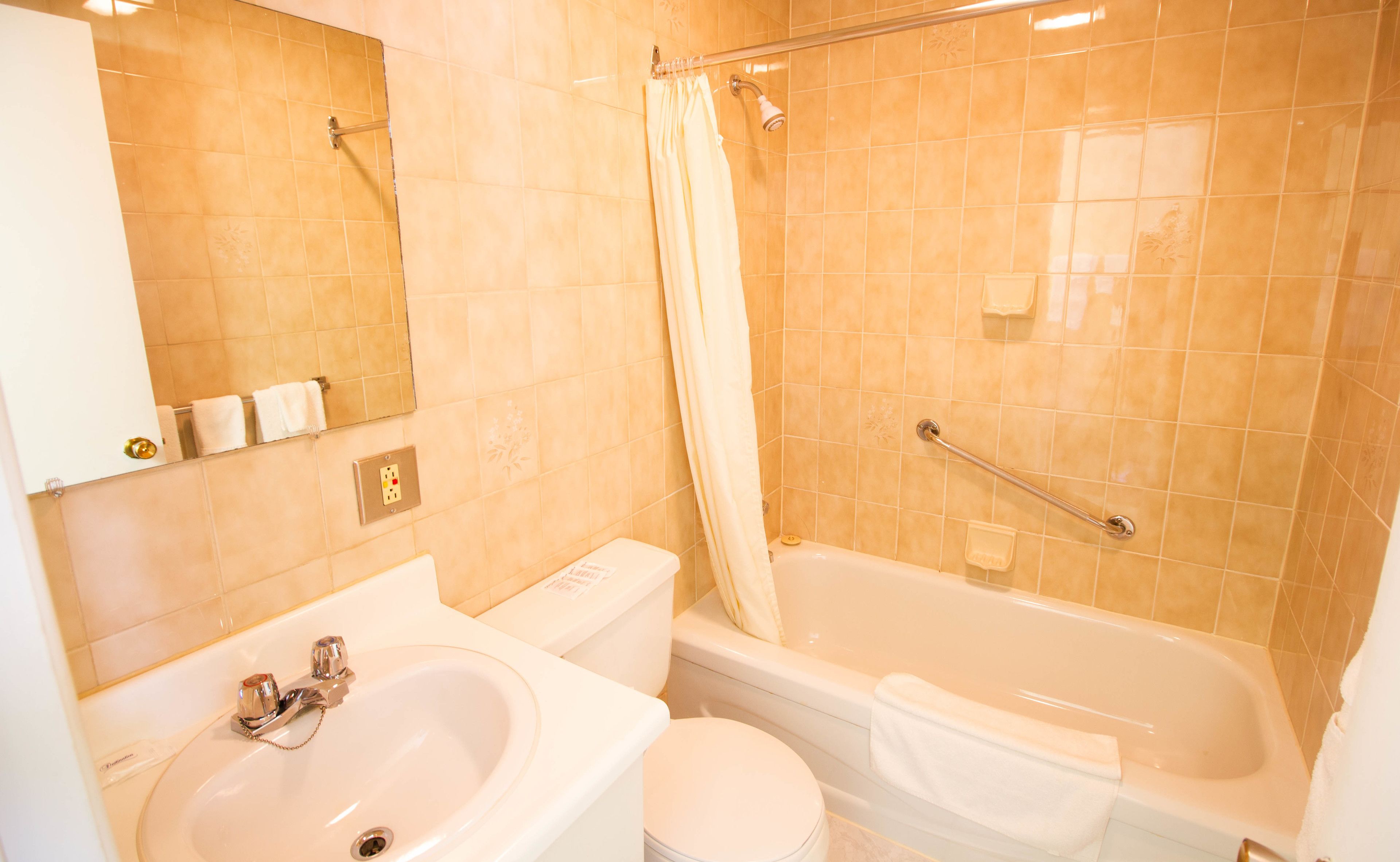 A bathroom with a sink, toilet, and bathtub.