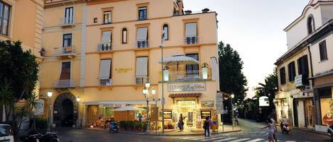 A multi-story building with a ground-floor shop and a restaurant.