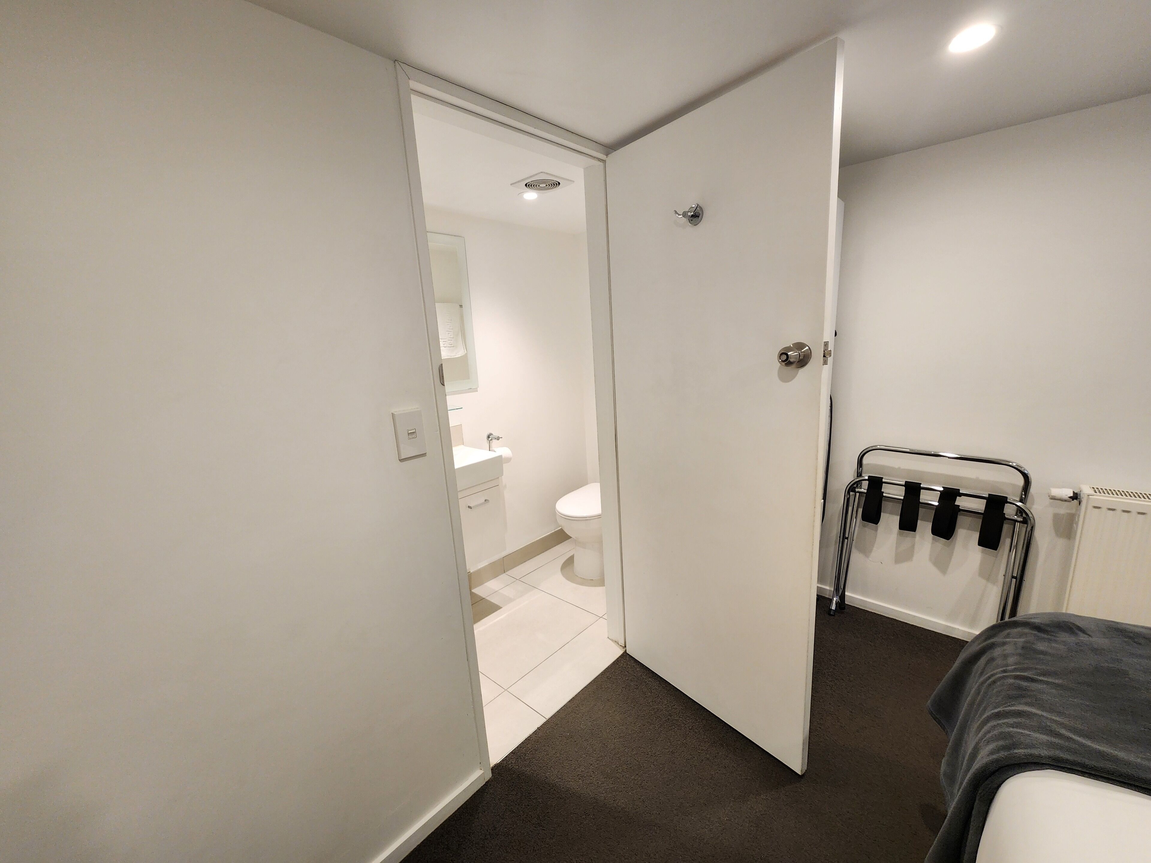A modern bathroom with a toilet, sink, and shower area.