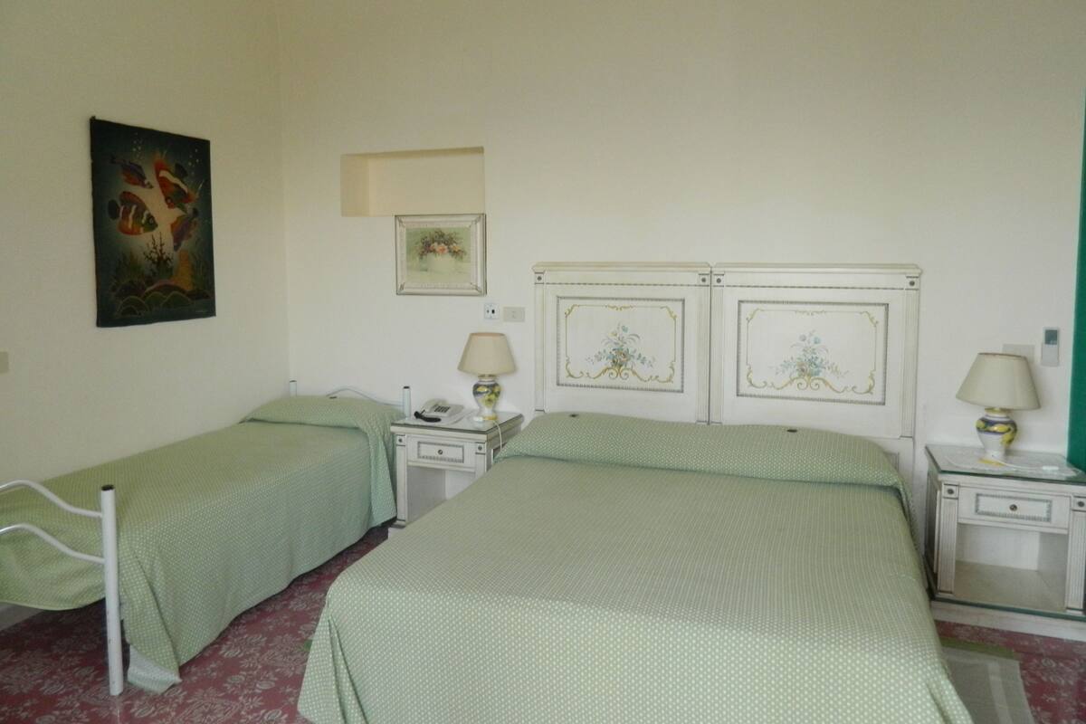 Triple Room | Minibar, in-room safe, desk, cots/infant beds