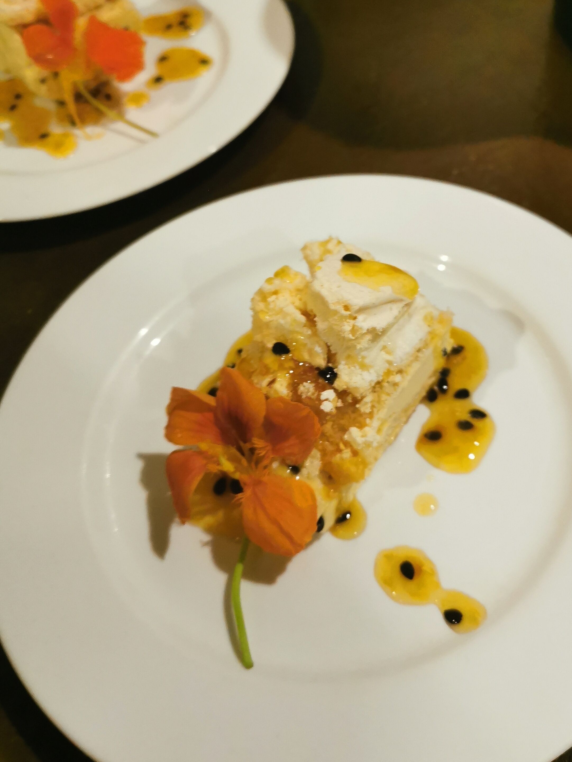 A dessert on a white plate with a flower garnish.