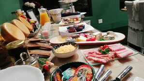 A breakfast buffet with various food items and condiments.