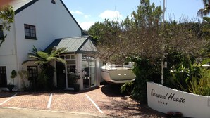 A white building with a sign reading "Edenwood House."