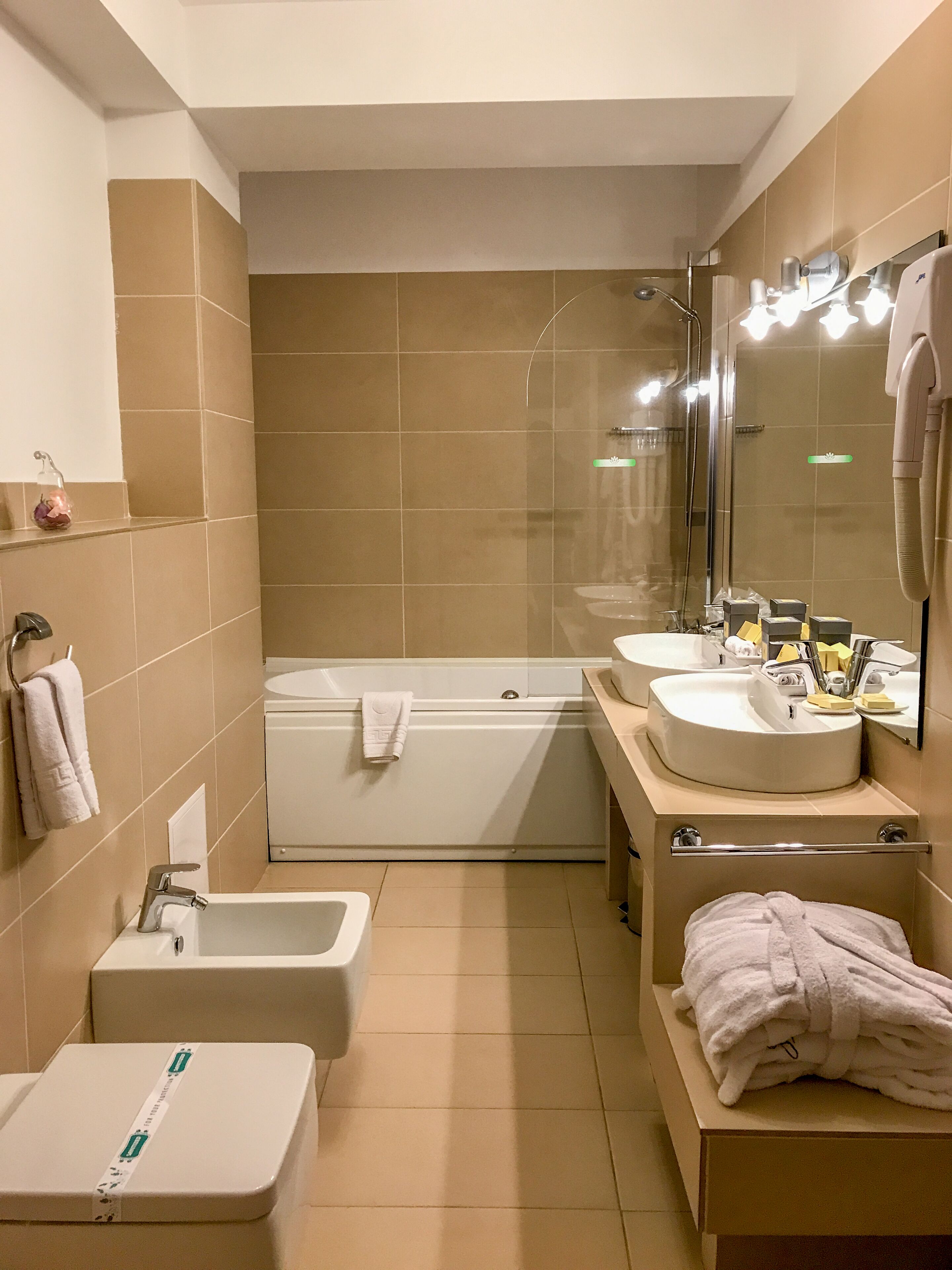 deluxe suite | bathroom | hair dryer, bathrobes, slippers, bidet