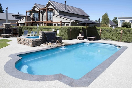 Outdoor pool, open 8:30 AM to 9:30 AM, pool umbrellas, sun loungers. Wanaka Luxury Apartments