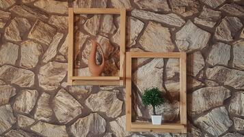 Two wooden frames with a stone wall background.