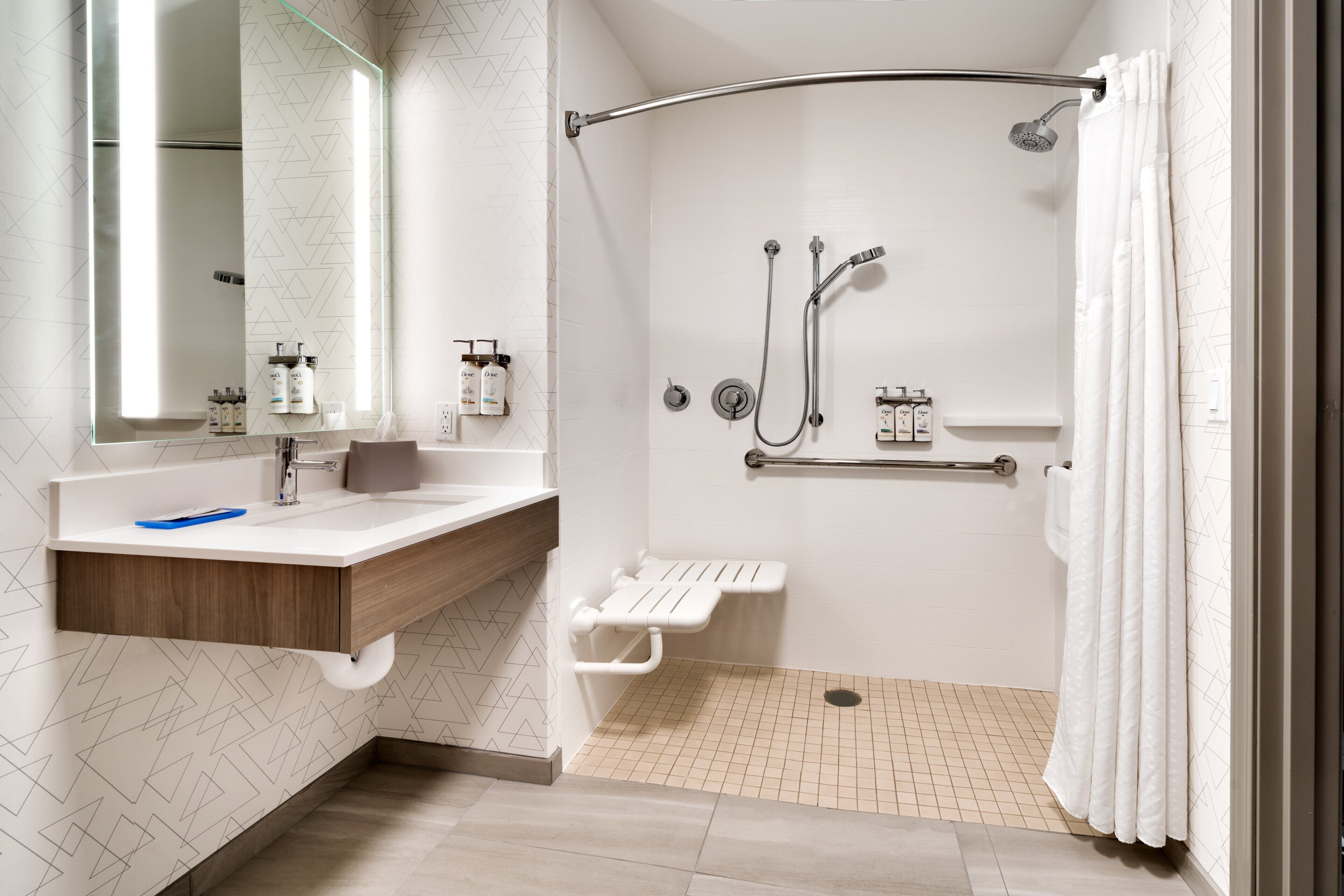 A modern bathroom with a shower, toilet, and vanity.