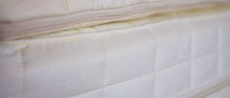 A close-up of a mattress with visible stitching and a zipper.