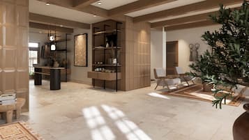 Un espacio habitable amplio con techo alto, estanterías de madera integradas, una planta grande en maceta y una zona de estar con mesa de centro.
