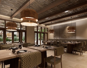 A restaurant interior with high ceilings, woven pendant lights, and a view of greenery outside.