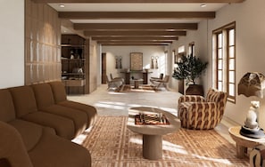 A spacious living area with a sofa, armchairs, a coffee table, and a chessboard.
