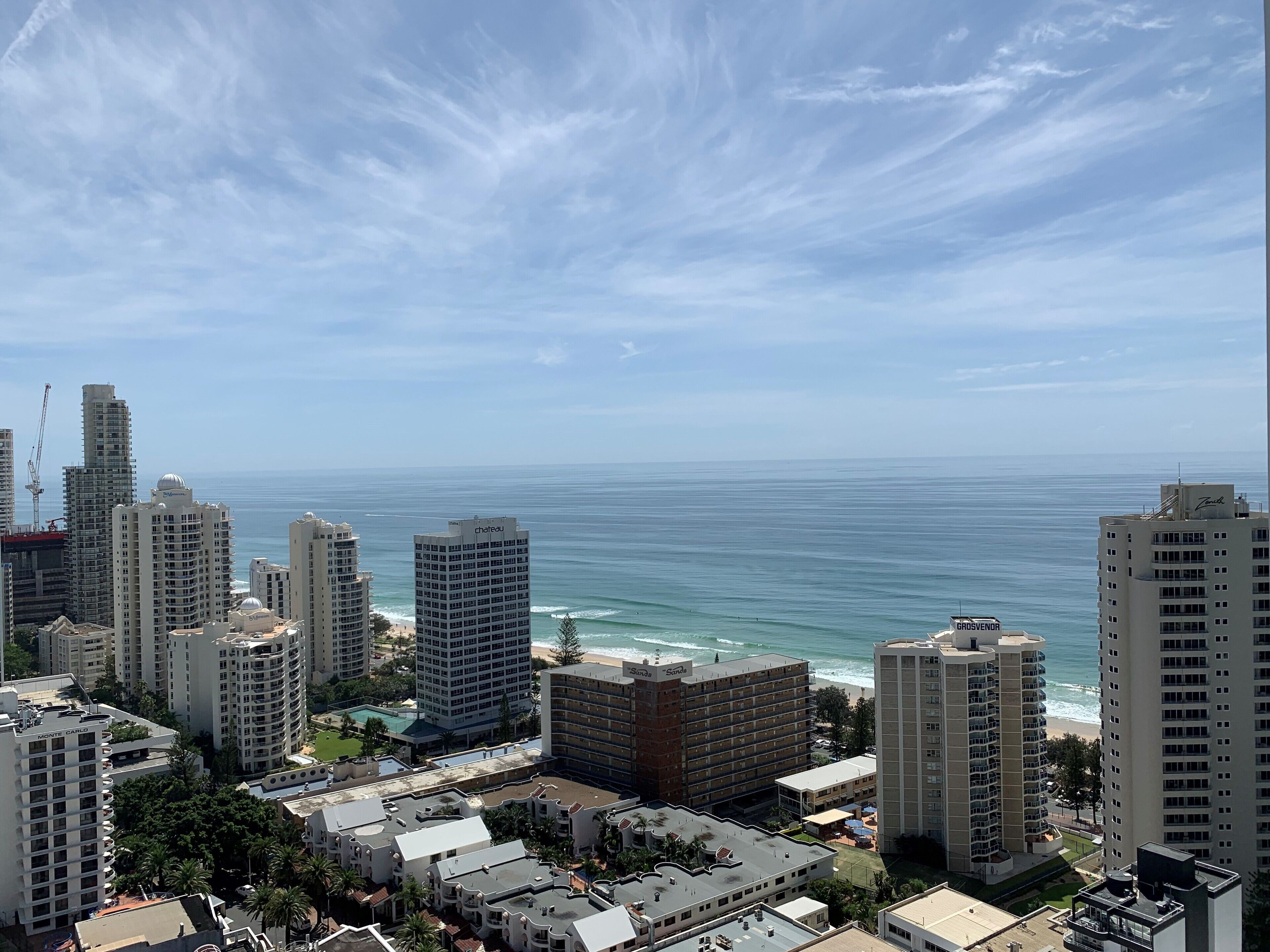 Un paisaje urbano costero con edificios altos, una playa y el océano.