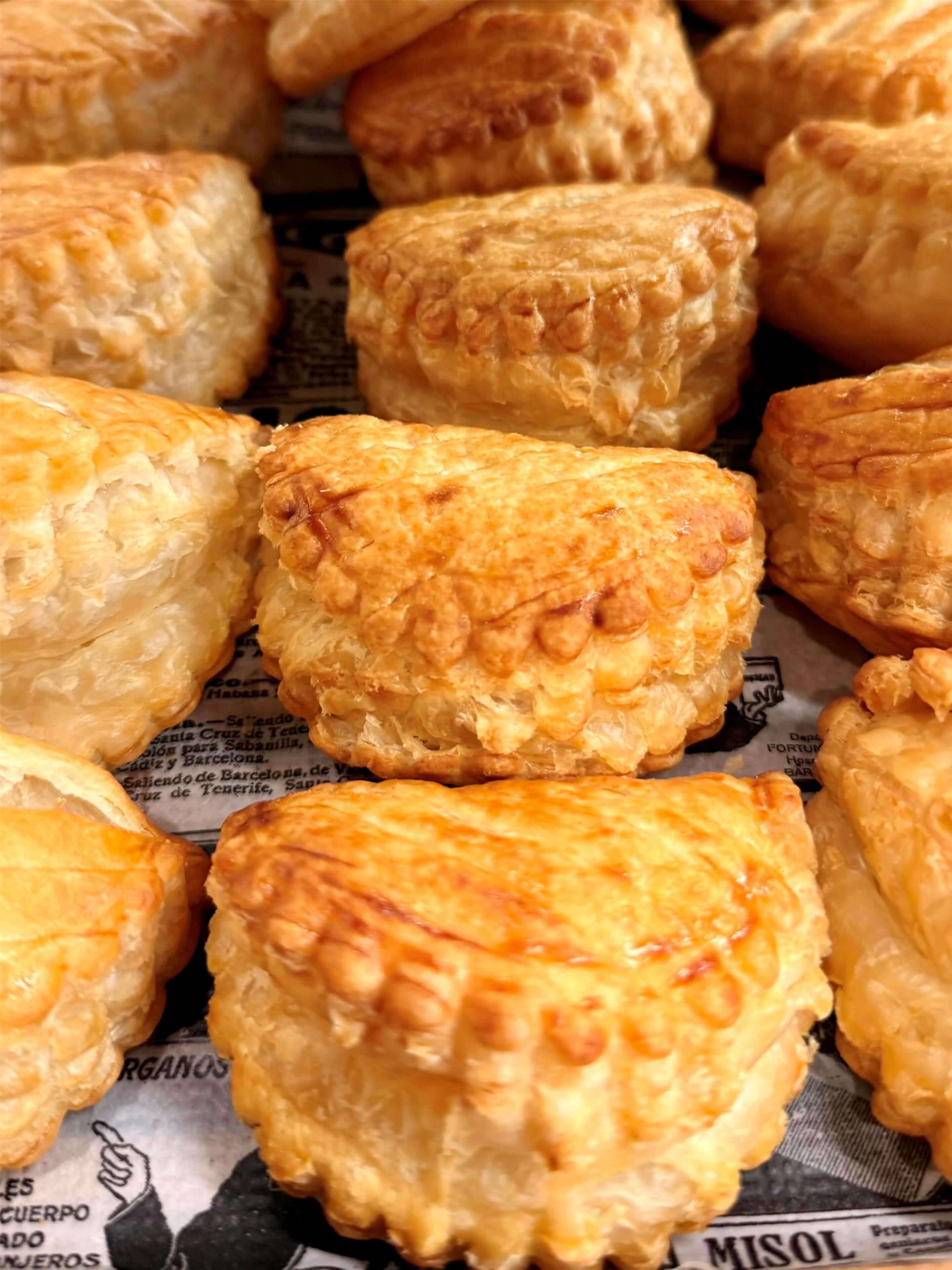 A variety of pastries on a newspaper.