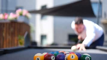 A pool table with numbered balls in a casual setting.