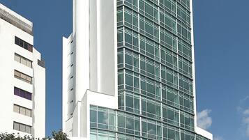 A modern building with a glass facade and a flat roof.