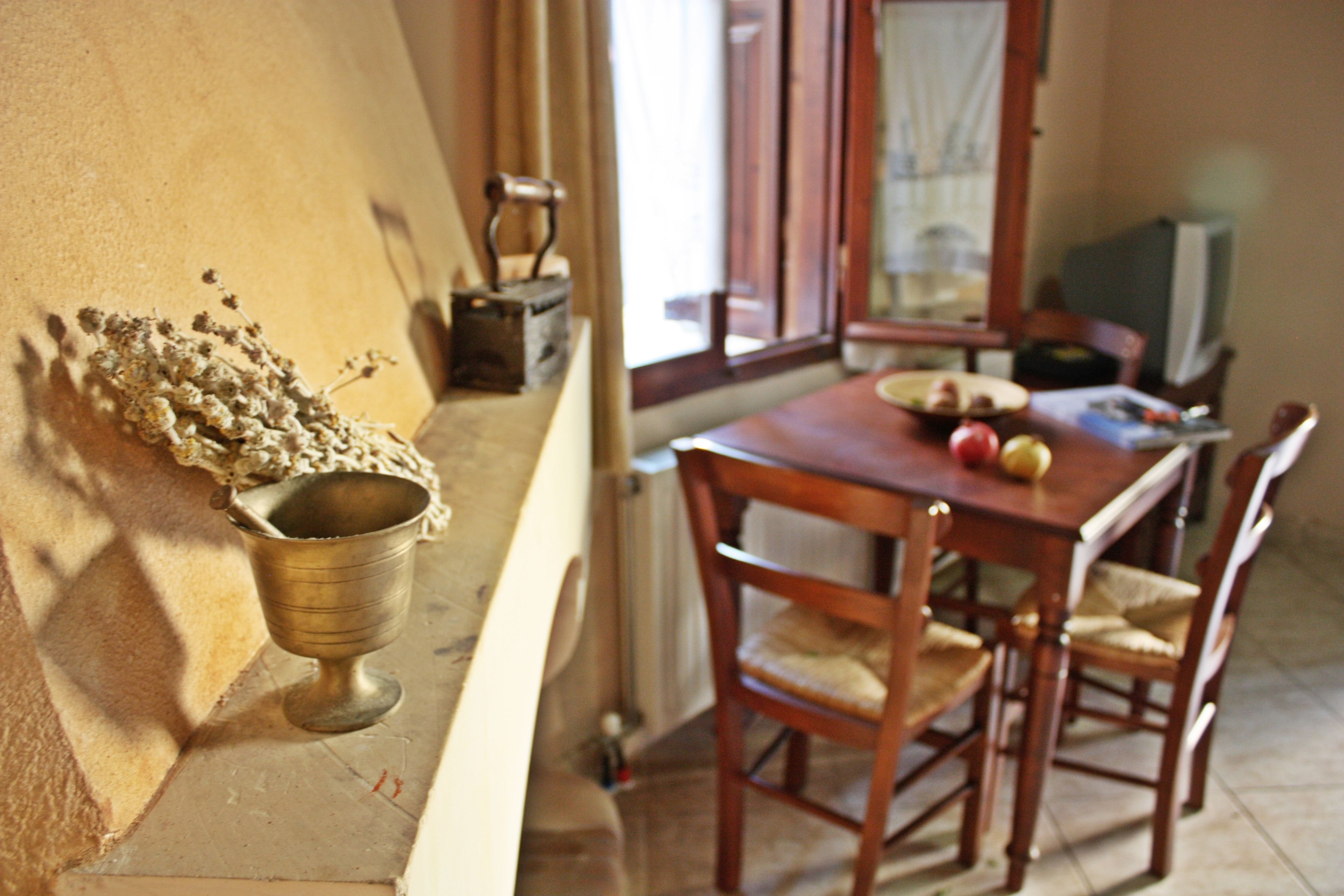 A dining area with a wooden table, chairs, and a window.