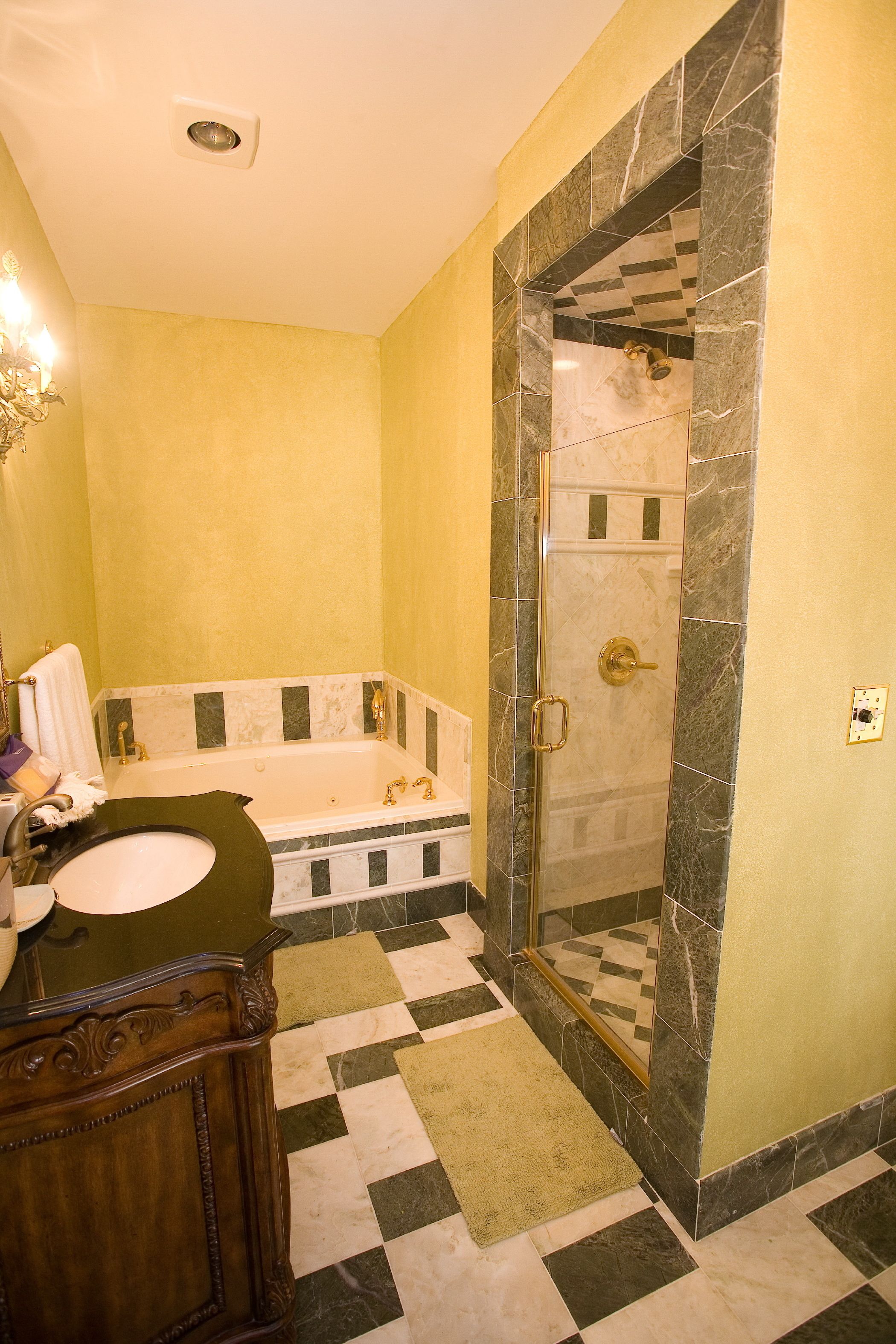 A bathroom with a bathtub, a shower, and a sink.