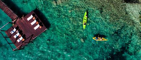 An aerial view of a resort with a wooden pier and a boat dock.
