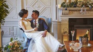 Enjoy a romantic evening in this elegant room with a fireplace, champagne and a beautiful floral arrangement.