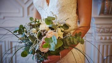 A person holding a bouquet of flowers.