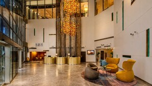 A spacious lobby with a reception desk, seating area, and a large chandelier. - Millennium Central Dubai Downtown (Dubai)