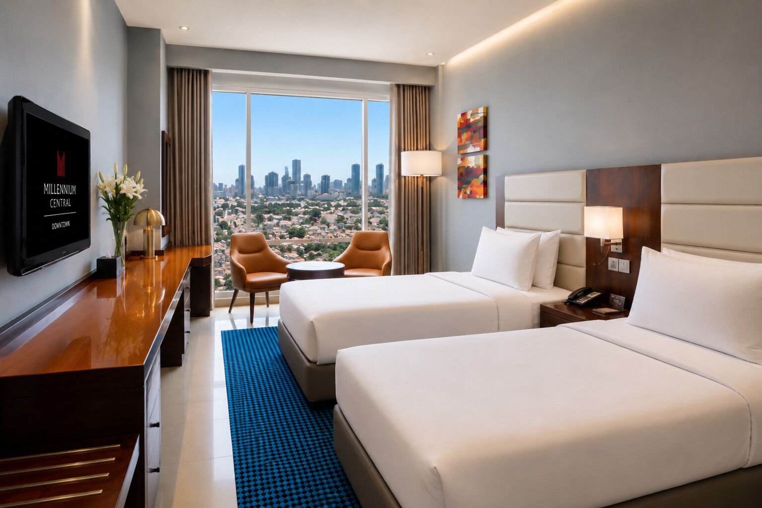 Quarto de hotel com duas camas, uma mesa, televisão e vista para a cidade.