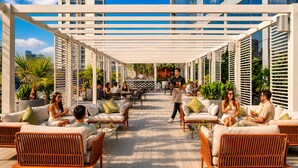 An outdoor seating area with wicker furniture, a pergola, and potted plants. - Millennium Central Dubai Downtown (Dubai)