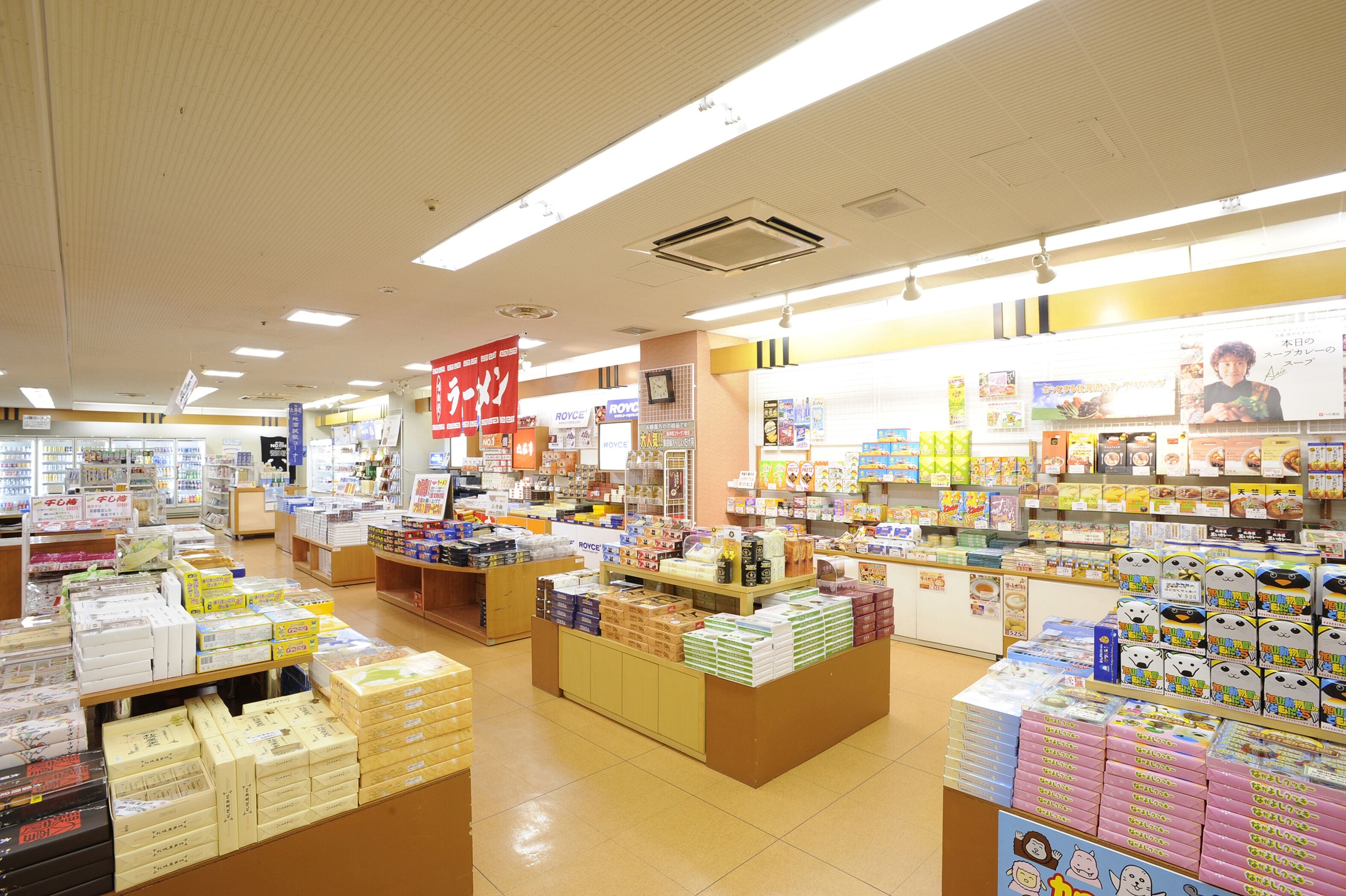 A brightly lit store with various products on shelves and counters.