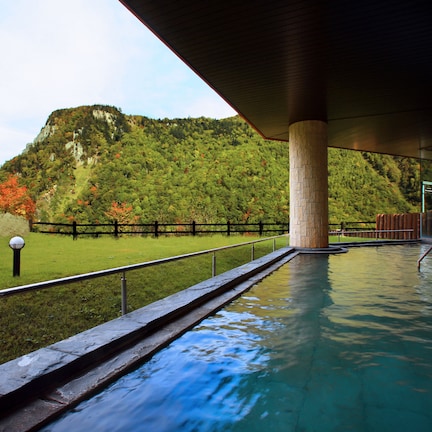 A pool area with a view of a mountainous landscape.