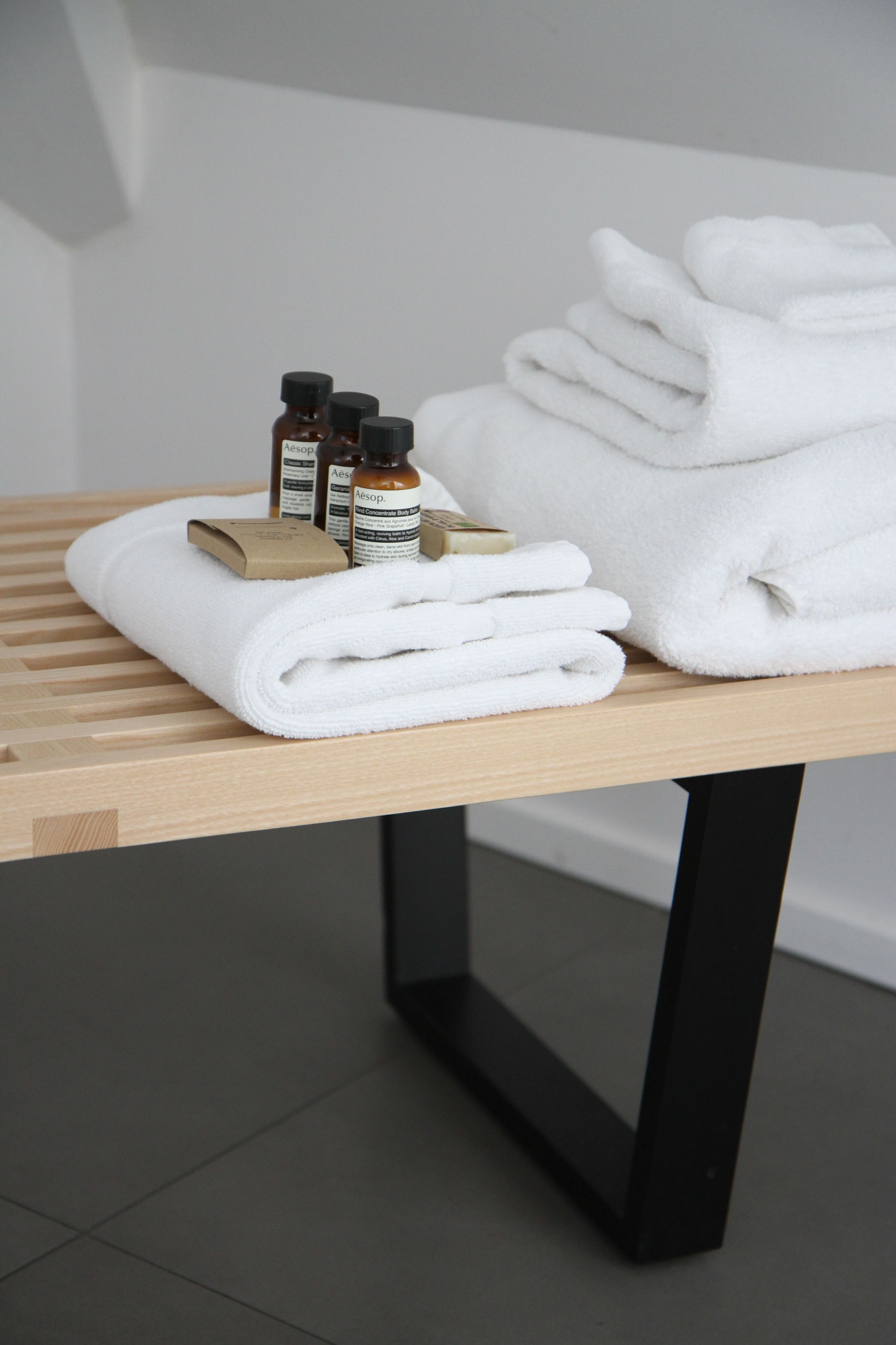 designer toiletries, bathrobes, slippers, towels