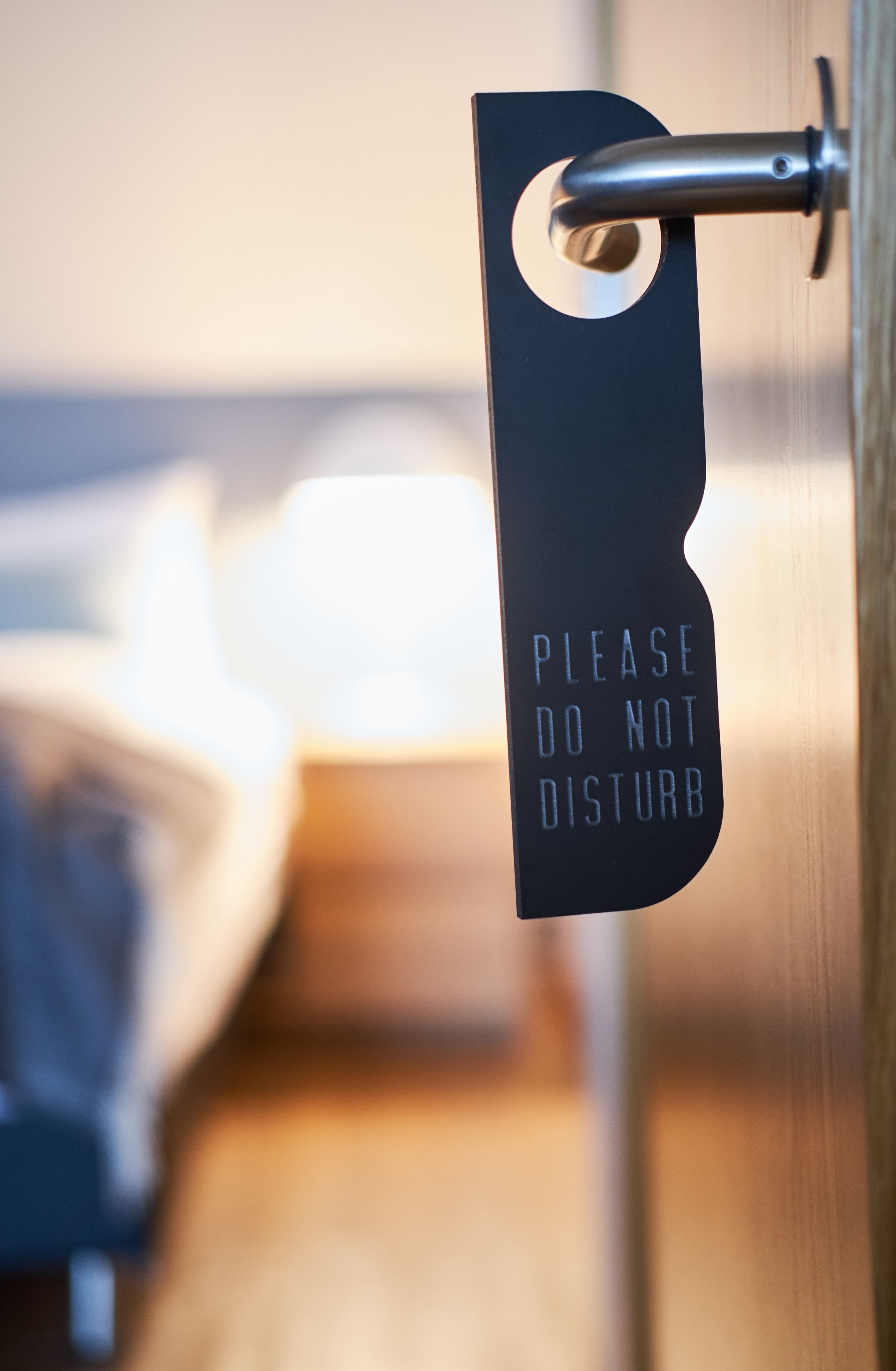 A sign on a door that reads "PLEASE DO NOT DISTURB."