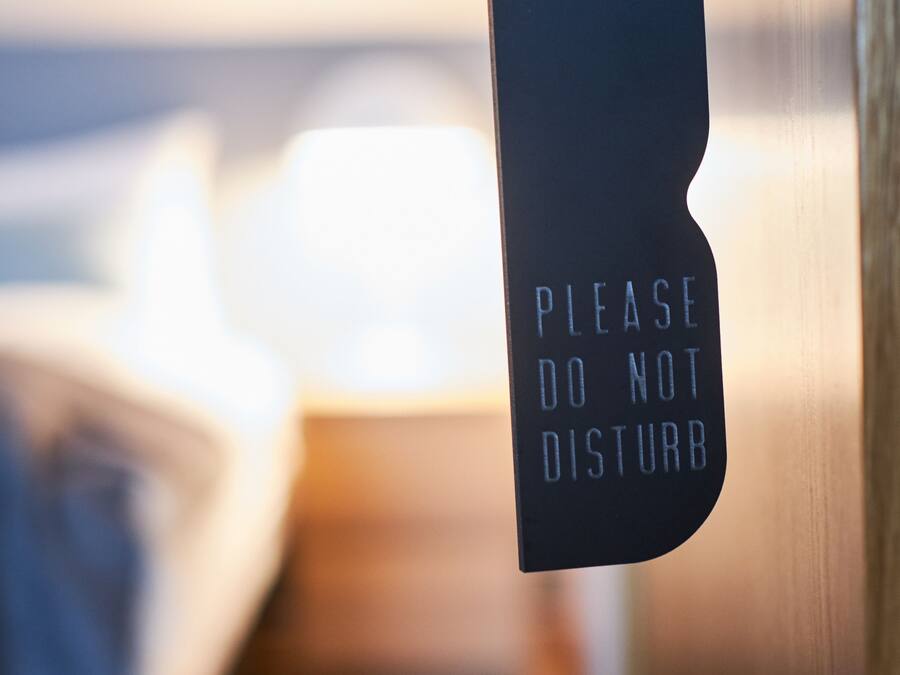 A sign on a door that reads "PLEASE DO NOT DISTURB."