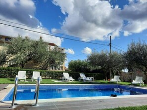 Seasonal outdoor pool, open 8 AM to 9 PM, pool umbrellas, pool loungers