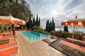 Seasonal outdoor pool, open 10:00 AM to 9:00 PM, pool umbrellas