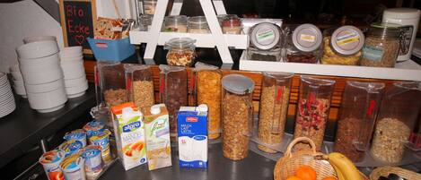A breakfast buffet with various food items and beverages.