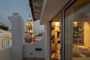 A hotel room with a view of a historic building with a clock tower. - Delirio (Cartagena)