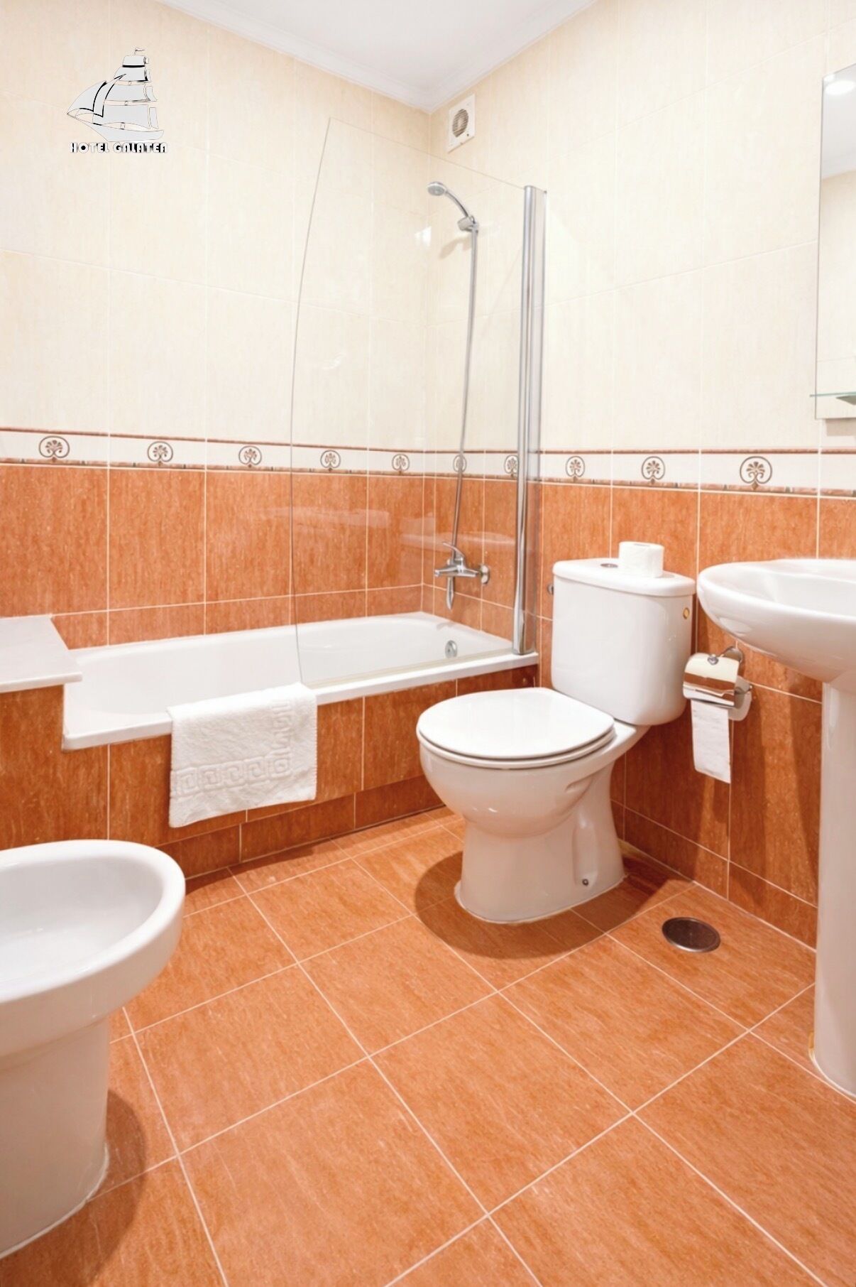 A bathroom with a bathtub, toilet, and sink.