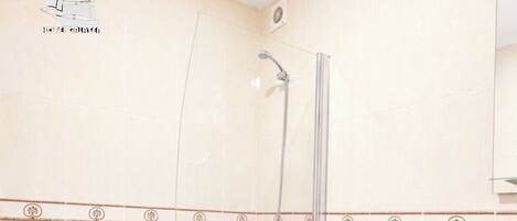 A bathroom with a bathtub, toilet, and sink.