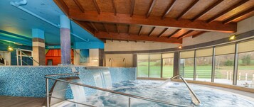 A hot tub with a tiled wall and a wooden ceiling.