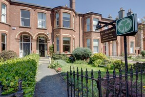 A traditional brick building with a sign for St. Aiden's Guest and Short Term Accommodation. - St. Aiden's Guesthouse (Dublin)