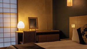 A hotel room with a bed, bedside table, lamp, and a mirror. - Hotel Vista Premio Kyoto Kawaramachi St. (Kyoto)