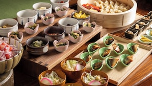 A variety of dishes and bowls on a wooden table, likely in a restaurant setting. - Hotel Vista Premio Kyoto Kawaramachi St. (Kyoto)