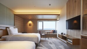 A hotel room with two beds, a dining area, a TV, and a large window offering a city view. - Shima Kanko Hotel The Classic (Shima)