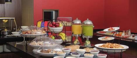A buffet with various food items and beverages.