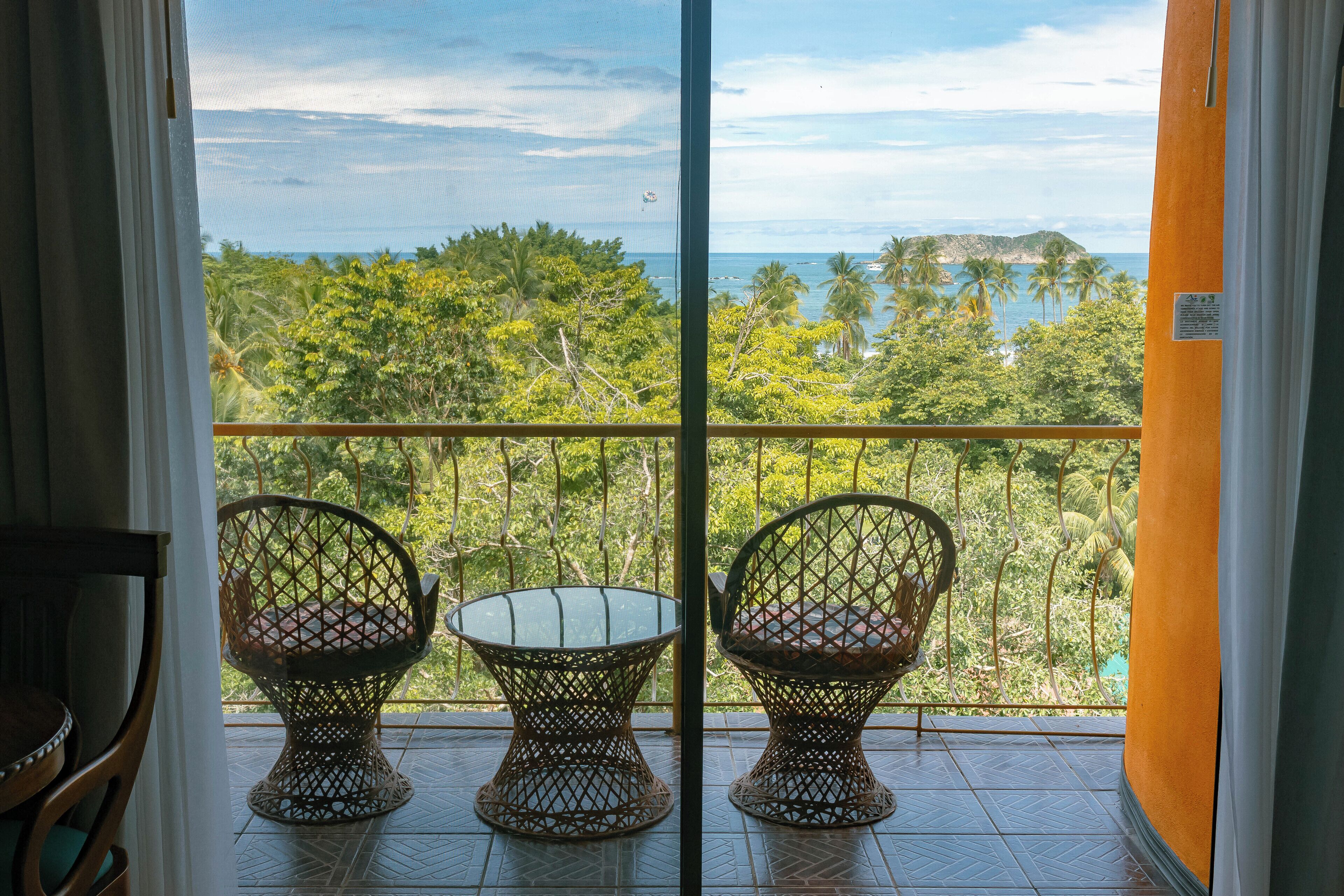 deluxe room with partial ocean view, one king bed | beach/ocean view