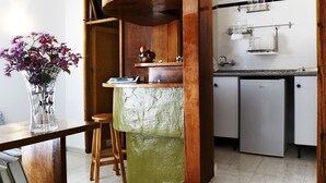 A kitchen with a wooden island, a refrigerator, and a sink.
