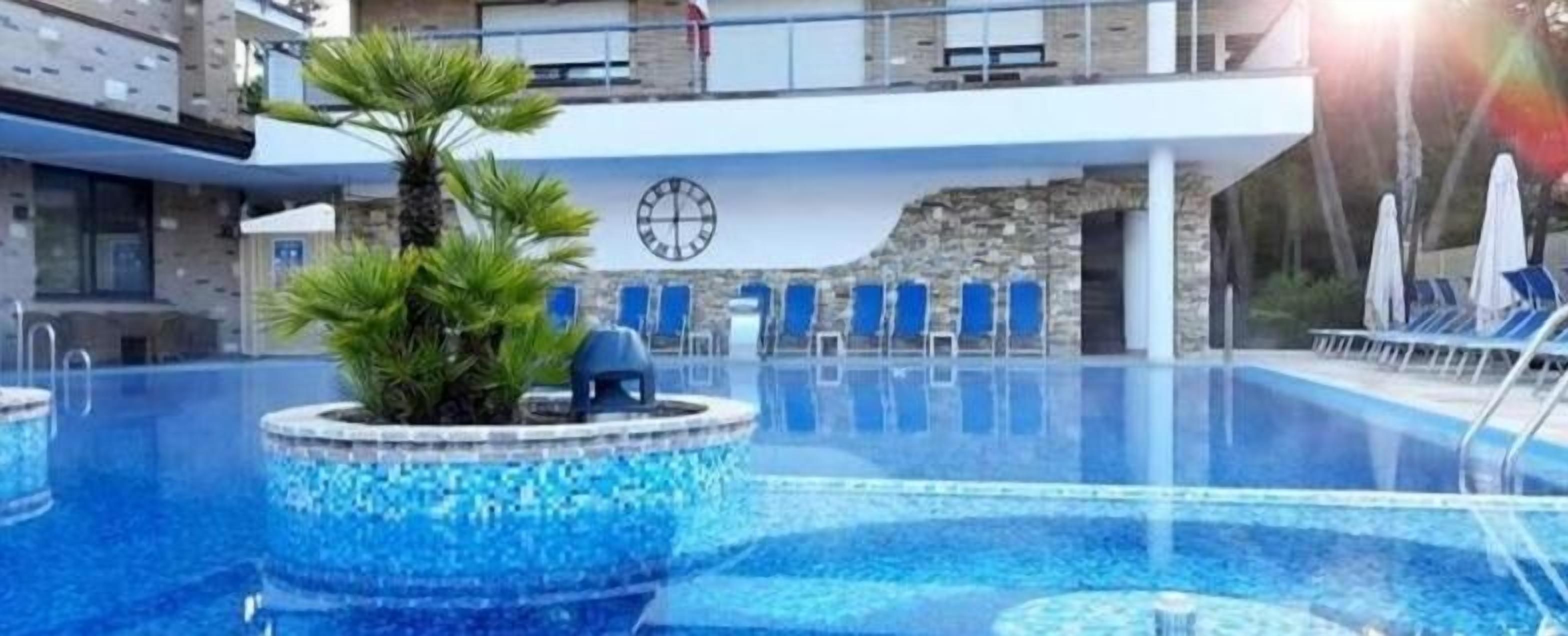 outdoor pool, open 8:00 am to midnight, pool umbrellas, pool loungers